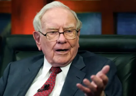 Calm investor reviewing stock market charts at a home desk during a market downturn