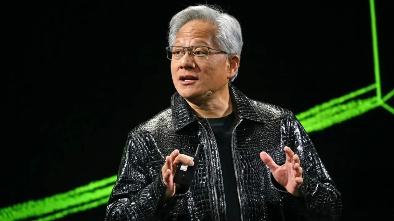 Tech executive speaking on stage at AI keynote event with blue lighting