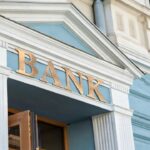 Commercial bank building entrance with federal regulatory examination seal