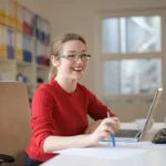 A customer looking at a bank balance notification on a smartphone showing a temporary deposit hold