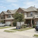Texas homes with signs representing a property tax protest and mortgage escrow review