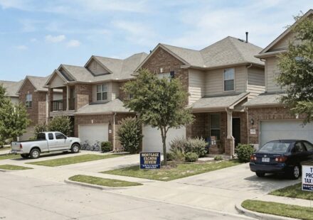 Texas homes with signs representing a property tax protest and mortgage escrow review